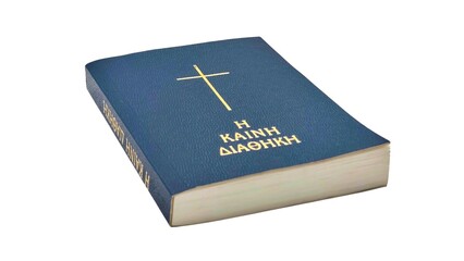 Closeup view of a blue hardcover Greek New Testament (KAINE DIATHEKE) bible, isolated on white background.