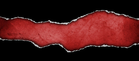Ripped black paper on red background