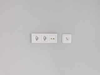 White electrical outlets on a soft gray wall creating minimalist vibe