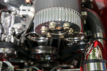 Close-up view of the engine compartment of a vintage car. Focus on foreground mechanical details.
