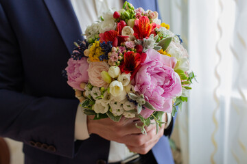 Man holding colorful bouquet of flowers