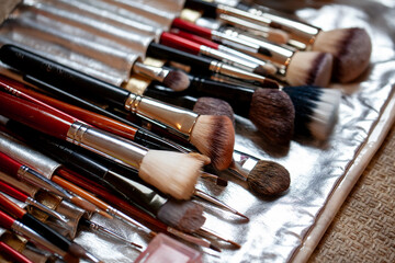 Assorted makeup brushes on a vanity surface