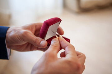 Groom Preparing for Wedding With Rings and Accessories
