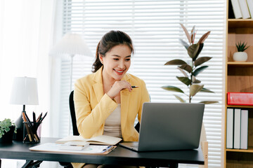 Young Asian woman doing financial accounting and taxes for a company Organizing account analysis...