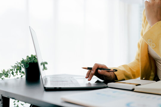 Portrait of a woman working on a tablet computer in a modern office. Make an account analysis report. real estate investment information financial and tax system concepts
