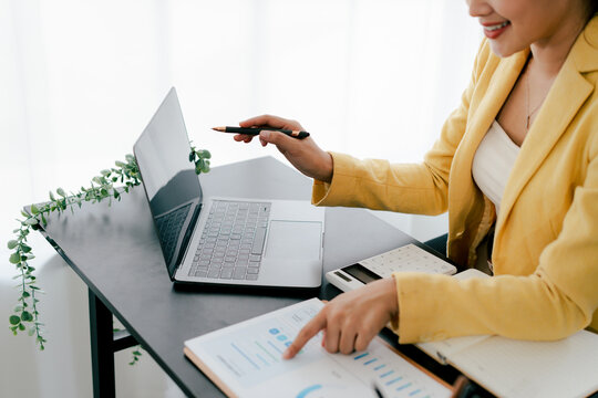 Portrait of a woman working on a tablet computer in a modern office. Make an account analysis report. real estate investment information financial and tax system concepts