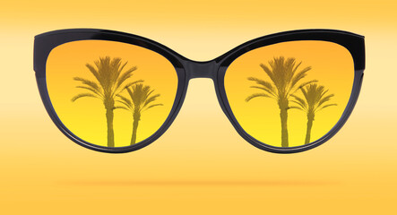 Bright sunglasses with reflection of palms on lenses against yellow gradient background