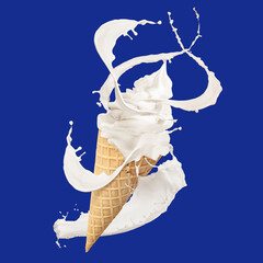 Tasty ice cream in waffle cone and milk splash against blue background