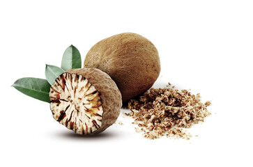 Nutmeg seeds with green leaves on white background. Aromatic spice