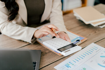 Portrait of a woman working on a tablet computer in a modern office. Make an account analysis...
