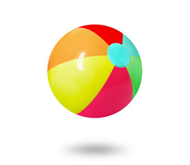 Bright beach ball falling against white background