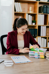 Female employee working with pile of documents to search for information and check documents on desk in office. Accounting income, expenses, tax records and hard work.