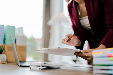 Asian business woman Business document check, account check, document search Legal documents, document preparation, reports, tax analysis, time, accounting, data sheets
