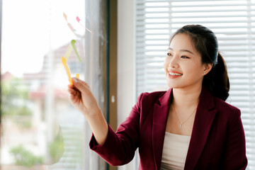 Female secretary working in office. Young woman checking business documents, checking accounts, searching documents, tax, accounting.