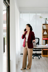 Asian businesswoman chatting on smartphone, auditor, document search, report, analysis, tax, accounting, document, data, contract, agreement at work.