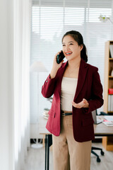 Asian businesswoman chatting on smartphone, auditor, document search, report, analysis, tax, accounting, document, data, contract, agreement at work.