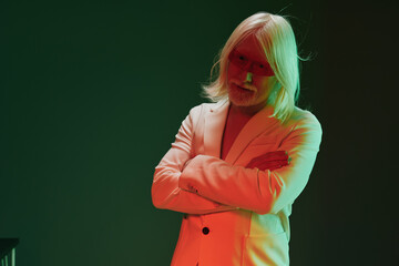 Portrait of a contemplative individual with long white hair dressed in a light colored suit,...