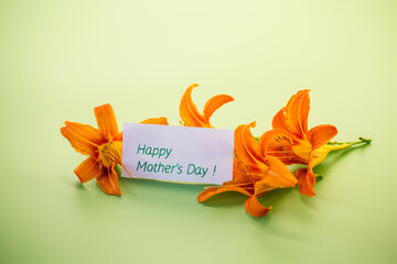 Top view of bright lilies with greeting card