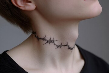 Close-up of a person's neck with a detailed black barbed wire tattoo wrapping around, emphasizing skin texture and minimalist body art style