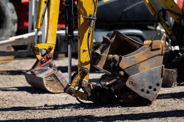 excavator buckets on construction site ground close up view heavy equipment attachments in use for...