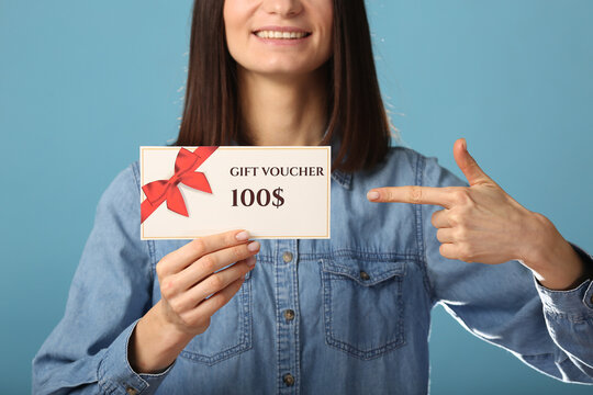 Young excited woman wear pajamas jam sleep eye mask rest relaxing at home point index finger on gift voucher flyer mock up isolated on pastel blue background studio. Good mood night bedtime concept - Powered by Adobe