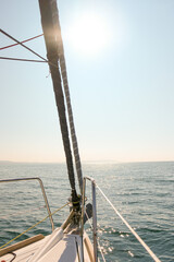Adventure on a sailboat, sailing into the horizon on a summers day showing the bow of a yacht with...