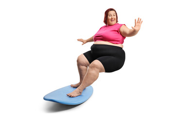 Corpulent woman riding a surfboard