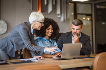 Helpful female boss mentor explain new project to diverse employers