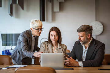 Helpful female boss explain new project to man and woman employers