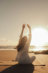 Asian woman in white clothes practice yoga for meditation and relaxation for healthy near seaside....