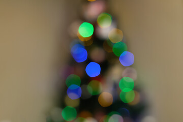 The enchanting glow of a Christmas tree, artfully blurred with shimmering bokeh in tranquil green...