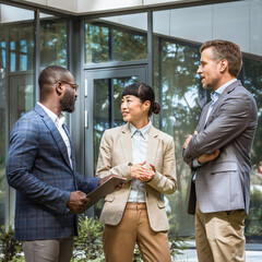 Multicultural business team having a discussion outdoor
