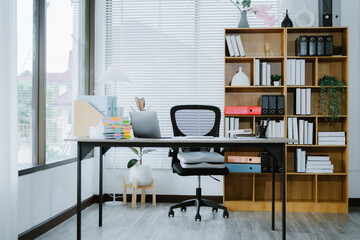 White office desk with digital tablet, a takeaway coffee cup, and stack of documents