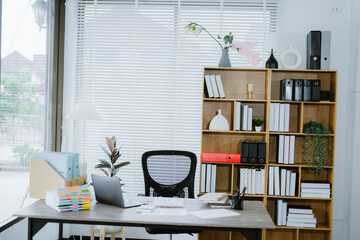 White office desk with digital tablet, a takeaway coffee cup, and stack of documents