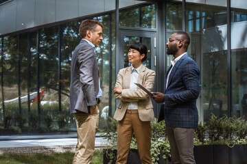 Multicultural business team having a discussion outdoor