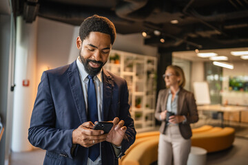 african american businessman use mobile phone in the modern office