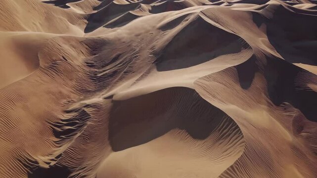 Wind carving golden sand dunes, exposing intricate landscape patterns through dynamic erosional processes in arid environment