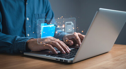 Person typing on laptop with digital file transfer graphic overlaying the keyboard and hands