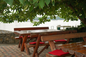 Red wooden benches and a table on the outdoor terrace