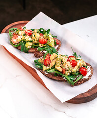 Avocado Feta Bruschetta with Arugula and Cherry Tomatoes on Multigrain Bread