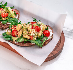 Avocado Feta Bruschetta with Arugula and Cherry Tomatoes on Multigrain Bread