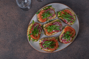 Sandwiches with sausage, egg, tomatoes and arugula