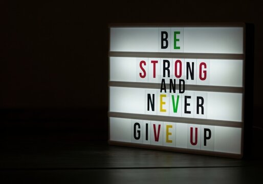 Inspirational message on lightbox be strong and never give up