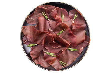 Spanish tapa Cecina meat slices, beef jamon on plate with herbs isolated on white background. top...