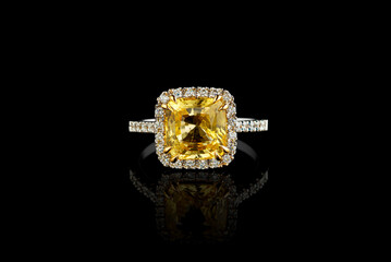 white gold ring with yellow sapphire stone, diamonds on black background
