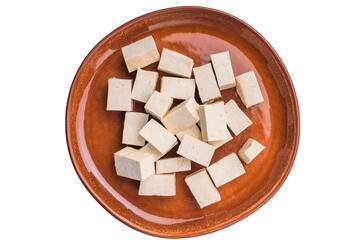 Uncooked Diced soybean tofu cheese on plate isolated on white background. top view