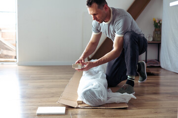 The furniture assembler assembles the bed frame, do it yourself and assemble new furniture