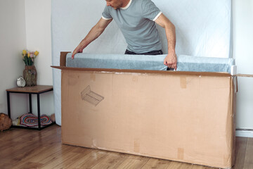 The furniture assembler assembles the bed frame, do it yourself and assemble new furniture