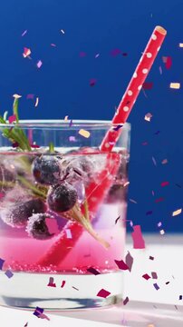 Animation of confetti falling and cocktail on blue background