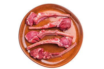 Uncooked lamb chops, fresh mutton meat steaks on a plate isolated on white background. top view